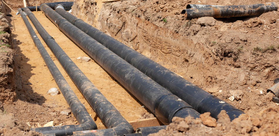 underground plumbing lines on a land with light brown dirt
